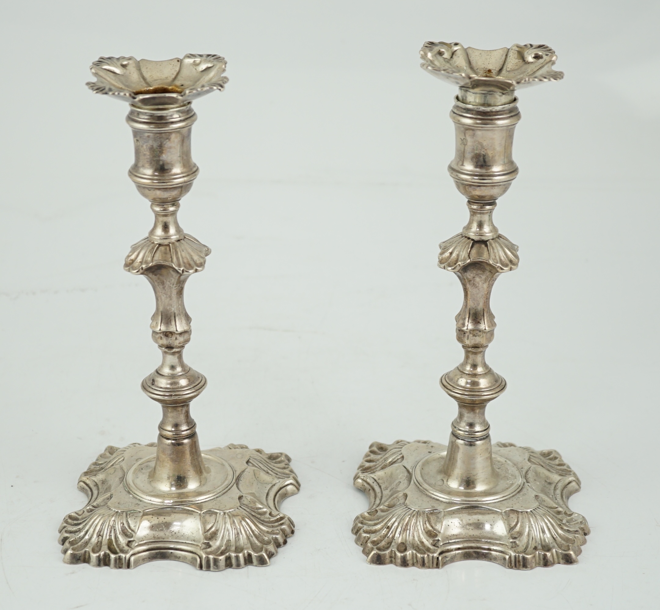 A pair of George II cast silver candlesticks by William Gould